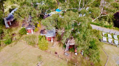 an overhead view of a house in the trees at Carriageway Retreat - Unique Red Rattler Carriages and Units in Brookfield