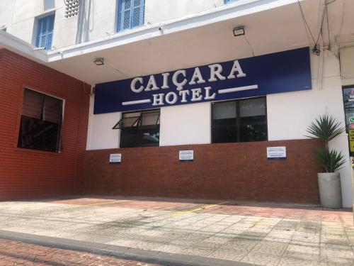 a building with a sign for a hotel at Caiçara Hotel in Santos