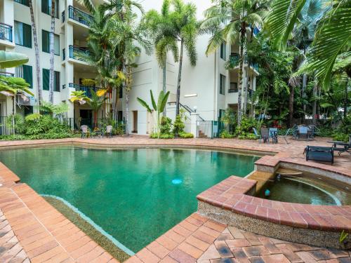 a swimming pool in front of a building at Cairns City Family Apartment - Wifi -Netflix - Pool in Cairns North
