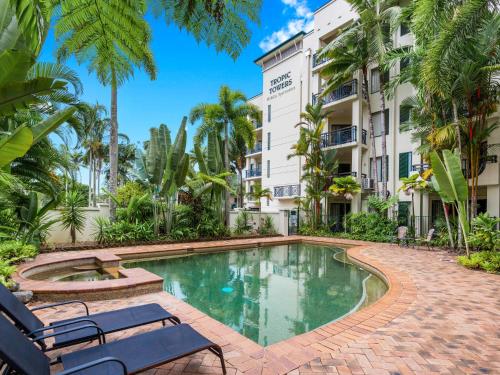 a swimming pool in front of a building at Cairns City Family Apartment - Wifi -Netflix - Pool in Cairns North