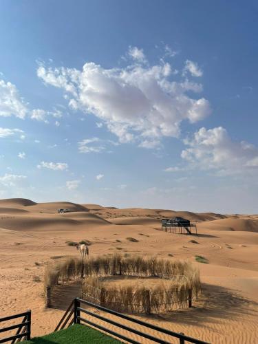 a fence in the middle of the desert at Moon Light Camp in Bidiyah