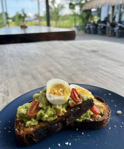 a piece of toast with an egg on top of it at BB Garden Resort in Canggu