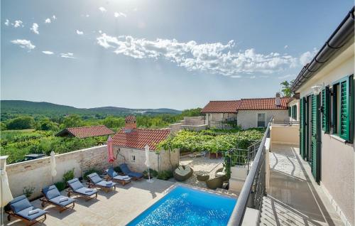 a balcony with chairs and a swimming pool on a house at Villa Torine in Zadar