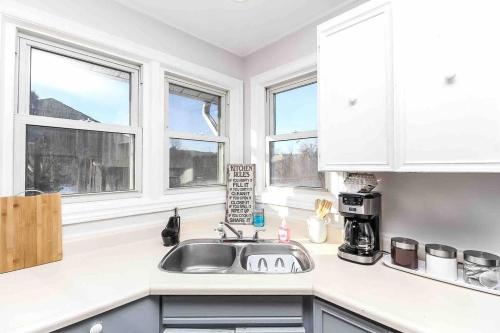 a kitchen with a sink and two windows at Farm House in Coldwater