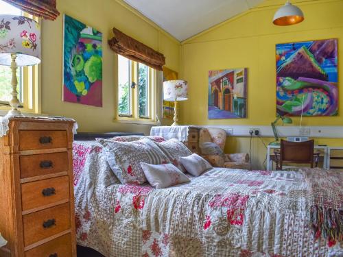 a bedroom with a bed and a dresser at Owls Nest in Stradbroke