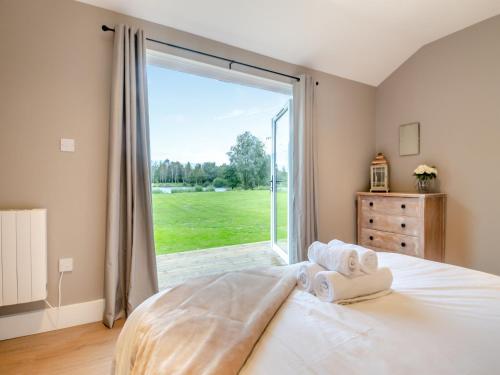 a bedroom with a bed and a large window at Stillwater in Rockland Saint Peter