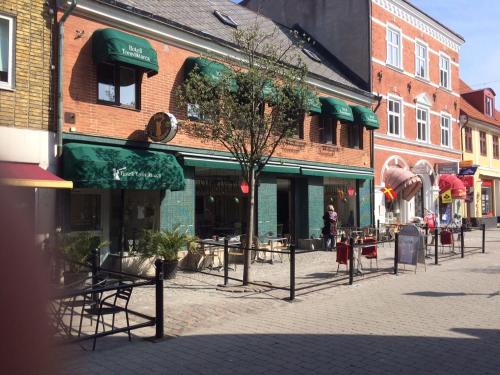 a street in a town with tables and chairs at Cameo Boutique Hotell in Ystad