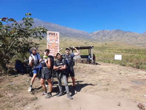 a group of people standing on a dirt road at Mount Rinjani Guest House in Sajang
