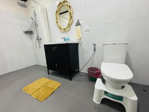 a bathroom with a toilet and a sink and a mirror at Mano Residence esidence in Luang Prabang