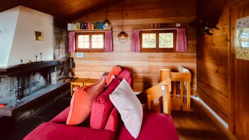 a person laying on a couch in a cabin at Chalet im Gus - Flumserberge & Walensee in Oberterzen
