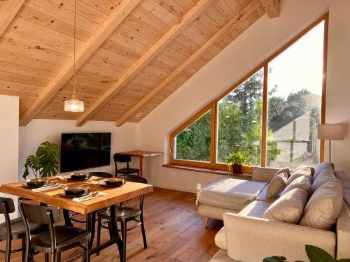 a living room with a couch and a table at Hiša PRI JEZERU in Dobrovnik