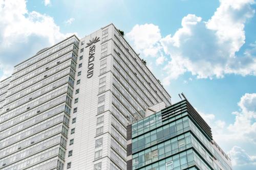 a tall white building with the name on it at Haeundae Seacloud Hotel Residence in Busan