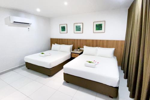 Postel nebo postele na pokoji v ubytování The Villa Langkawi