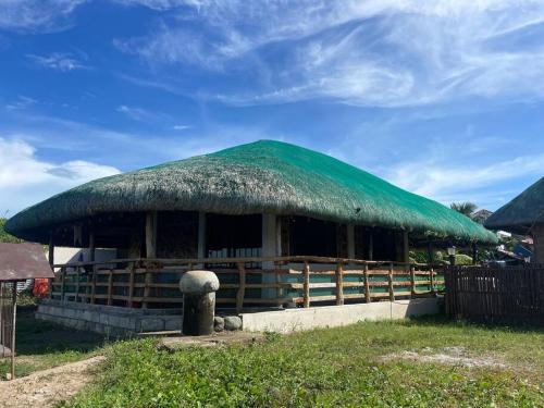 uma grande cabana com telhado de relva em Maria Kulafu Kubo House 1 BIG BEDROOM with Wifi em Masbate