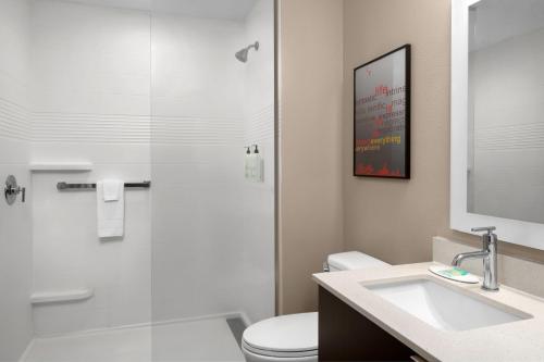 a bathroom with a shower and a toilet and a sink at TownePlace Suites by Marriott Kingsville in Kingsville