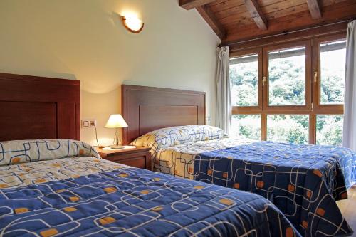 a bedroom with two beds and a window at Apartamentos Irati Olaldea in Oroz-Betelu