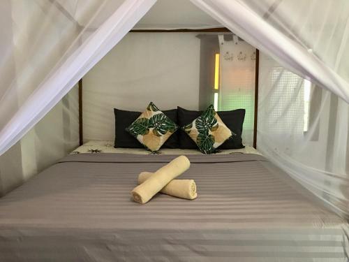 a bunk bed with two pillows and two logs on it at Starlight Beach Resort in Ko Phayam
