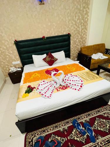 a bedroom with a bed with flip flops on it at Grand Mostafa Hotel Ababil in Sylhet