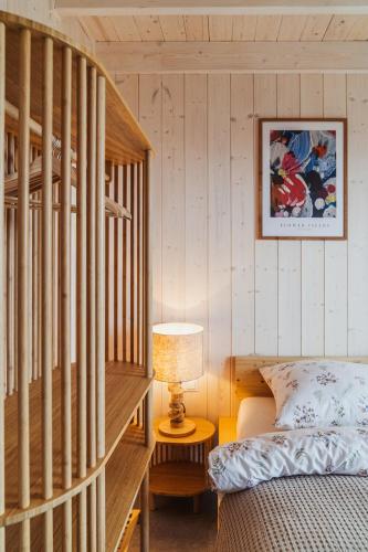 a bedroom with a staircase and a bed and a lamp at Garczovka - domki, jacuzzi, sauna in Garcz