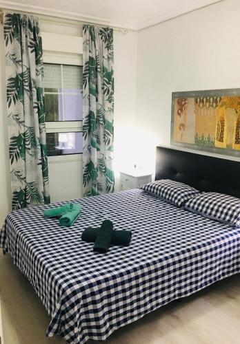 a bedroom with two beds with black and white sheets at Apartment Beach El Albir in Albir
