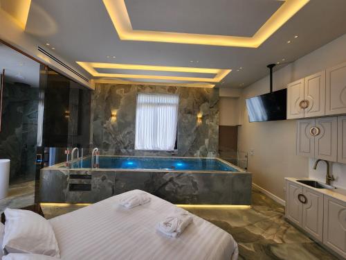 a bathroom with a tub and a bed and a sink at תבל PRIVATE HOTEL in Jerusalem