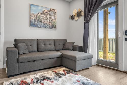a living room with a couch and a window at Sunny Walk-out Unit, Free HiSpeed Wi-Fi and Parking, Near Grocery in Calgary