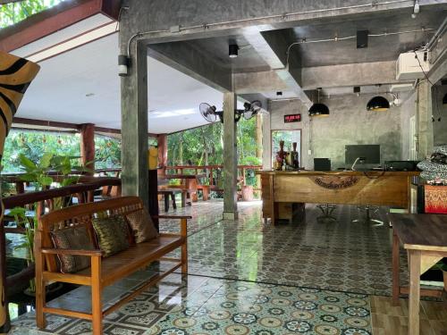 een lobby van een restaurant met een bureau en een piano bij Siam Lanta Resort - SHA Extra Plus in Koh Lanta