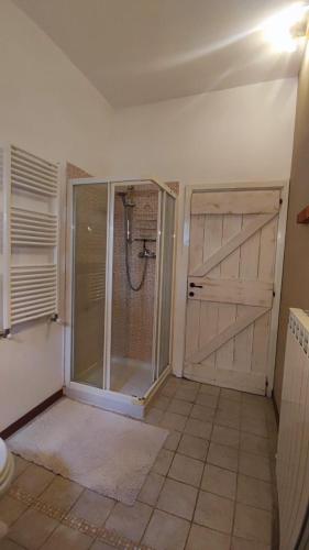 a bathroom with a shower with a sliding door at Camping Le Marche Apartments in Gualdo di Macerata