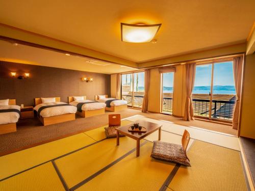 a hotel room with two beds and a view of the ocean at Yukai Resort Premium Hotel Ranpu in Hirado