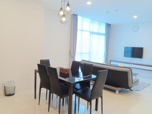 a dining room with a table and chairs and a couch at Formosa Spacious Apartments with Netflix & Pick Up Service by MESA in Nagoya