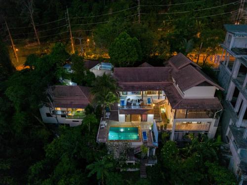 an aerial view of a house with a swimming pool at Villa Serenity pool SeaView 6BR in Kamala Beach