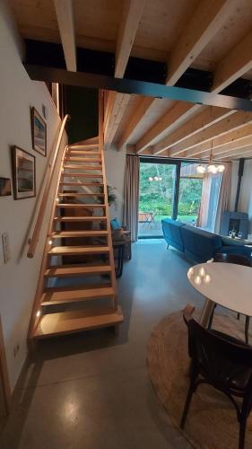 a staircase in a room with a couch and a table at Chez Rosé in Sainte-Cécile