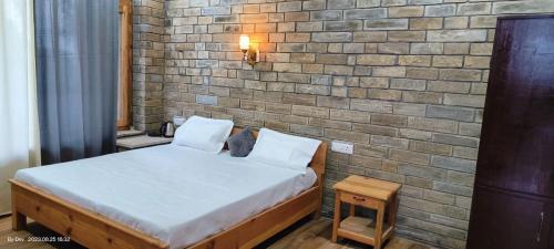 Postel nebo postele na pokoji v ubytování Ganesh Homesaty