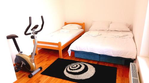 a small room with a bed and a scooter in it at Penthouse Danube Exclusive, Parking, 90m2, Wifi in Novi Grad