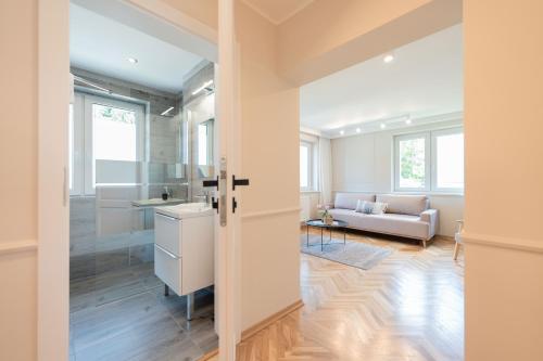 a kitchen and living room with a couch and a table at Apartamenty 39 z pięknym ogrodem in Ustroń