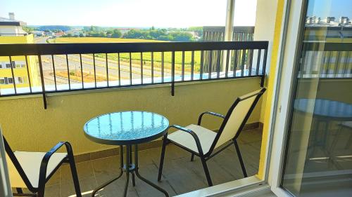 a balcony with a table and chairs and a view at Penthouse Danube Exclusive, Parking, 90m2, Wifi in Novi Grad