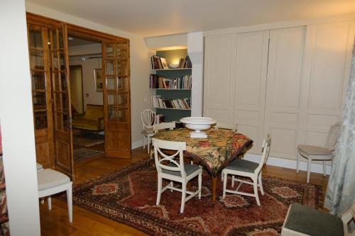 a dining room with a table and two chairs at CLOS DU BAILLI in Saint-Omer