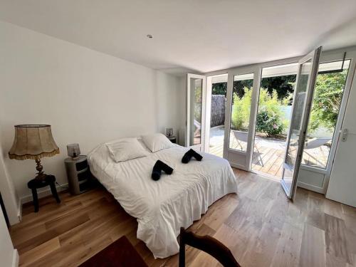 a bedroom with a bed with two black cats on it at Superbe villa avec piscine à 10 min du centre in La Rochelle