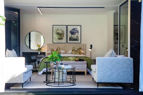 a living room with a bed and a table and chairs at Paarl Hideaway in Paarl