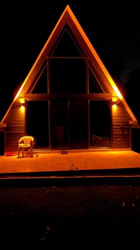 a bench sitting in front of a house at night at Ensagardenbungalov in Kartepe