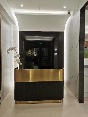 a lobby with a gold and black reception desk at Suzhou MeetU Intl Youth Hostel in Suzhou