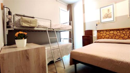 a bedroom with two bunk beds and a bed at Gli Ulivi Rooms in Lucca