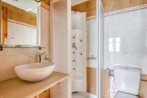 a bathroom with a sink and a shower and a toilet at Makrinitsa Village in Makrinitsa