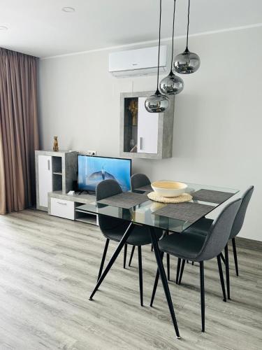 a dining room with a black table and chairs at A&V Studio in Green Park in San Miguel de Abona