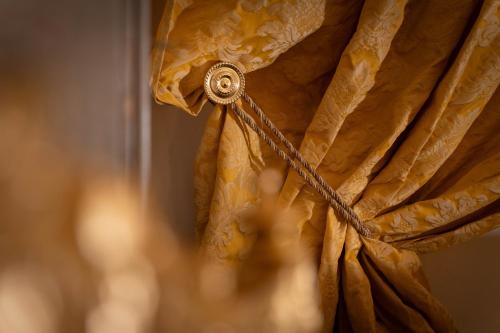 a close up of a curtain with a rope at San Giorgio Rooms in Genova