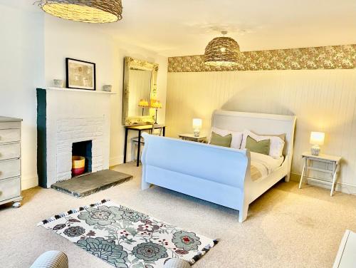 a bedroom with a bed and a fireplace at Hob Lane Farm Cottage in Oughtibridge