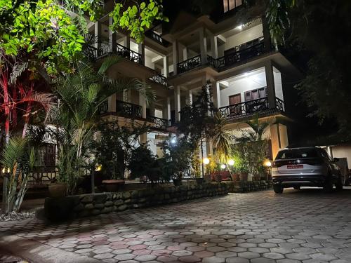 a car parked in front of a building at night at Sauraha BnB in Sauraha