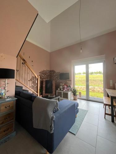 a living room with a blue couch and a table at Well-being in Eifel in Nettersheim