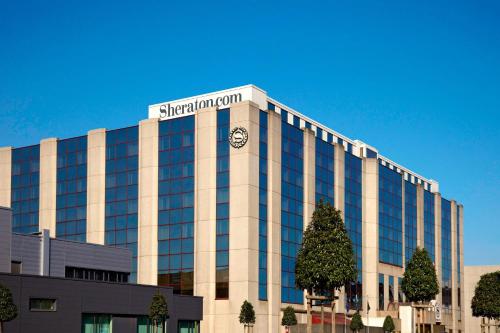 a building with a clock on the top of it at Sheraton Brussels Airport Hotel in Zaventem