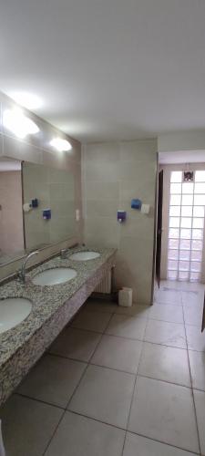 a bathroom with three sinks and a large mirror at SAMATYA APARTı in Istanbul